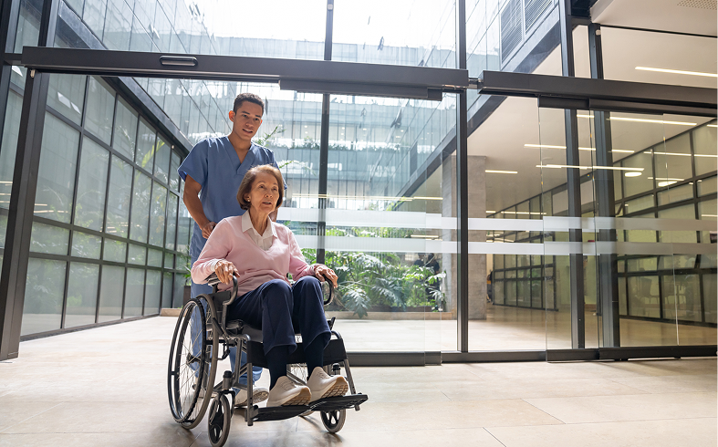 Medical professional with elderly patient in wheelchair