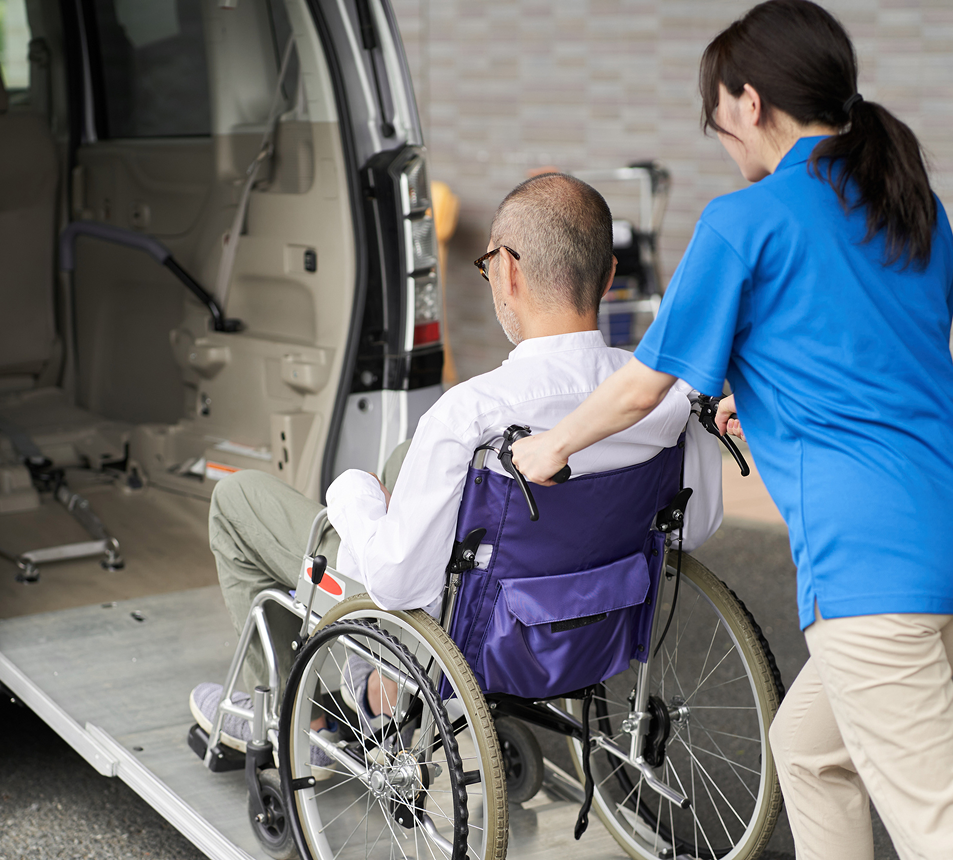 Wheelchair user being helped into van