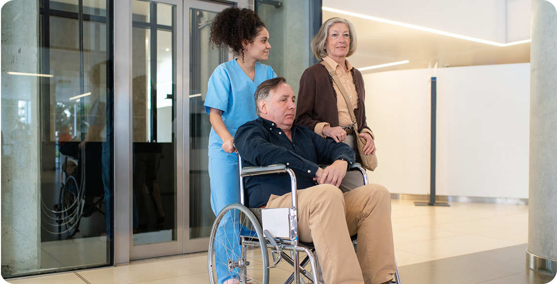Healthcare worker assisting man in wheelchair